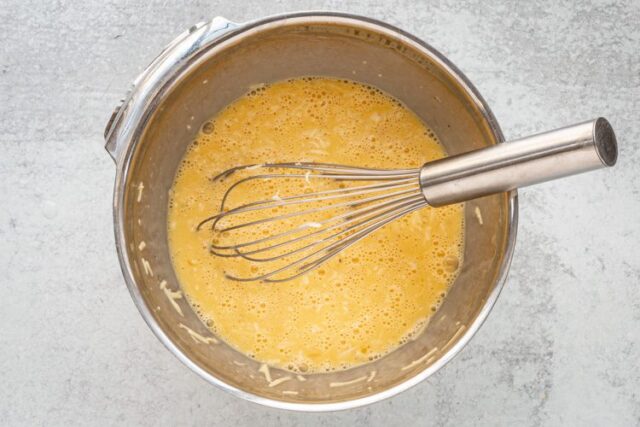 egg bites prep, mixing the eggs in a bowl
