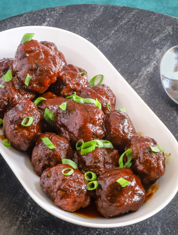 Air fryer meatballs with bbq sauce in a serving tray.