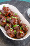 Air fryer meatballs with bbq sauce in a serving tray.