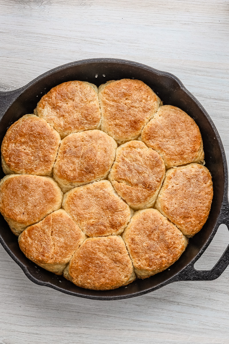 A skillet with fluffy baked angel biscuits.