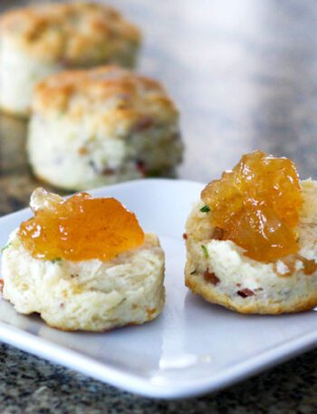bacon and chive biscuits on a plate with jam