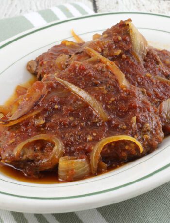 baked cube steaks in a tangy barbecue sauce with onions