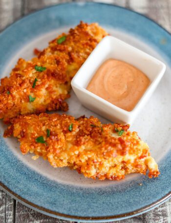 chicken strips coated with bacon and cheddar panko crumbs with spicy dip on the side