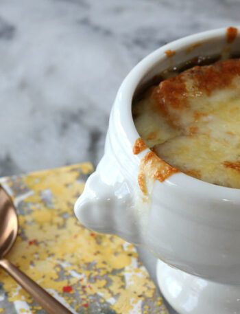 basic french onion soup in a bowl with melted cheese on top