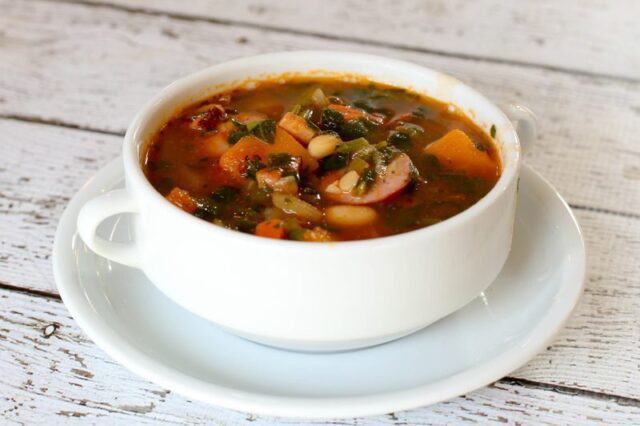bean and sausage soup in a bowl