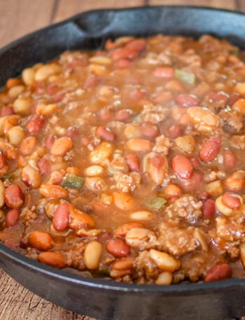 cookout beans with beef in a large iron skillet