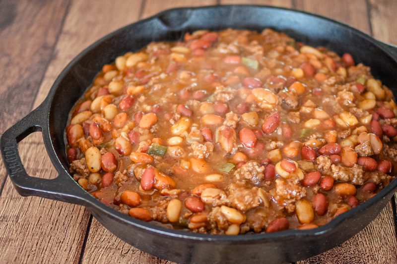 cookout beans with beef in a large iron skillet