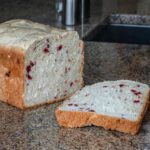 a sliced loaf of bread machine cranberry walnut yeast bread