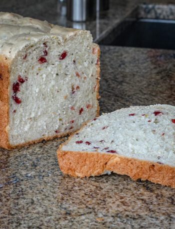bread machine cranberry bread sliced on the counter