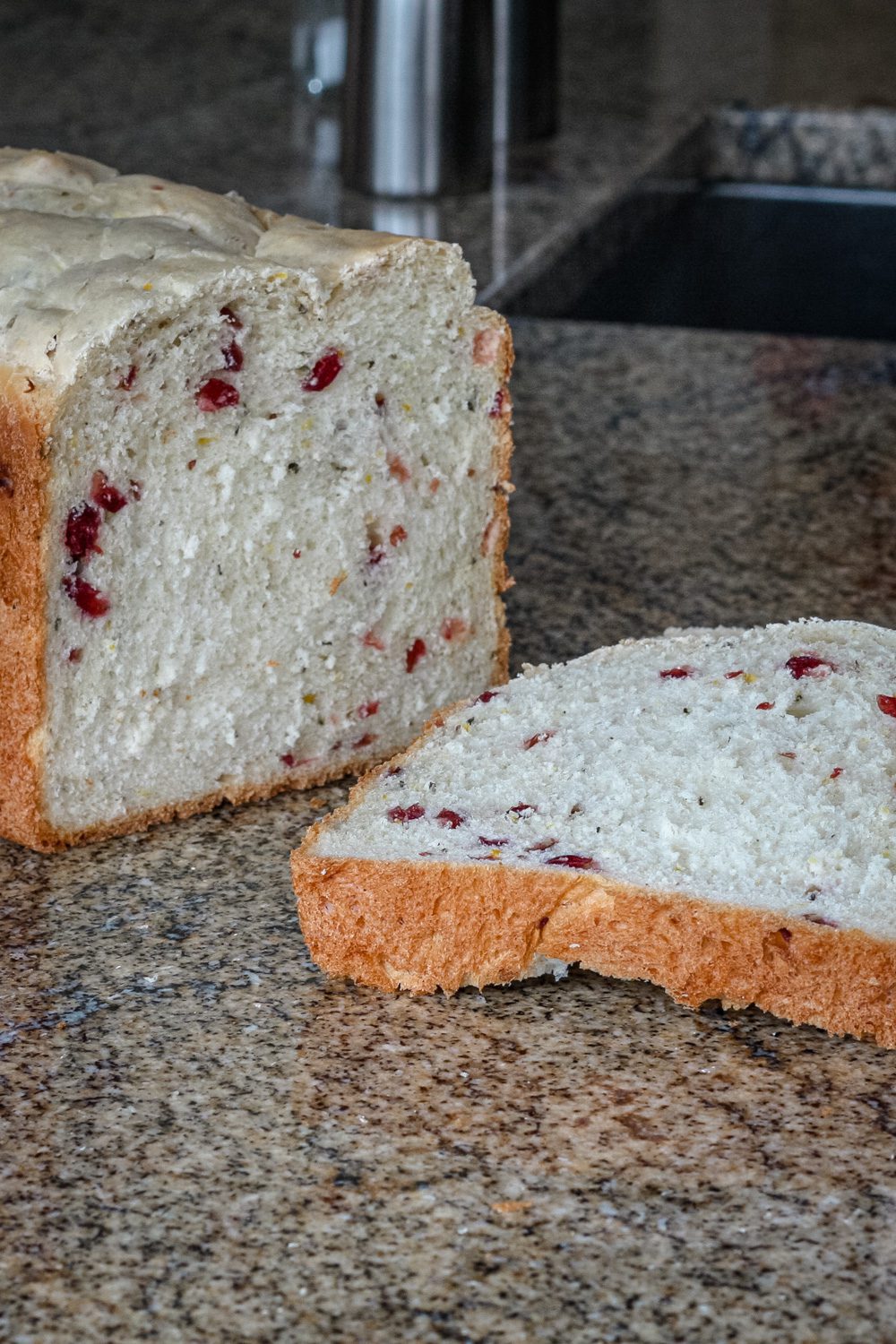 bread machine cranberry bread sliced on the counter