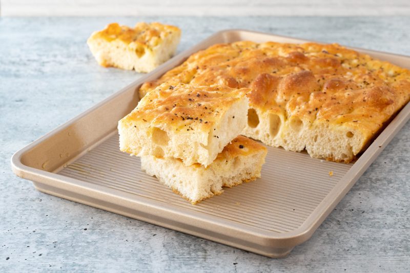 bread machine focaccia with slices in the pan