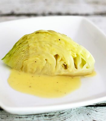 cabbage wedge with lemon sauce on a plate