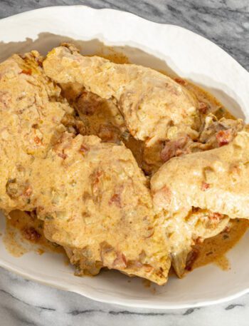 chicken paprikash with sour cream and paprika in a serving dish.