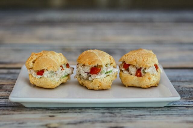 a trio of choux pastry puffs with chicken salad filling