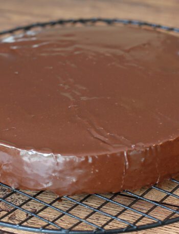 A cake layer covered with chocolate glaze