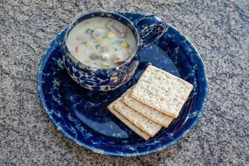 clam and corn chowder with crackers on the side