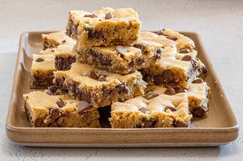 chocolate chip cookie bars stacked on a tray