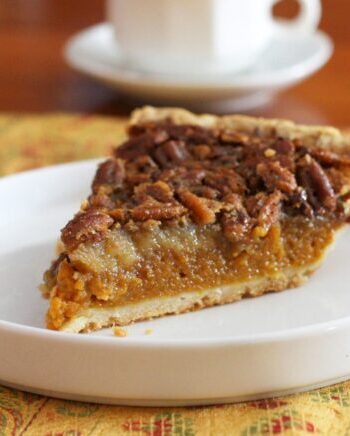 A classic pumpkin pecan pie on a dessert plate