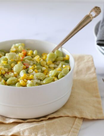 a serving bowl of succotash with corn and lima beans