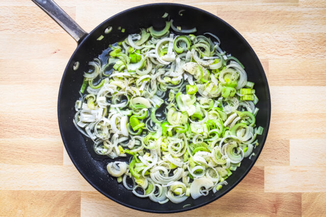 Leeks are cleaned, sliced and in the skillet to cook.
