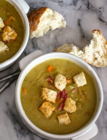 bowls of split pea soup and croutons