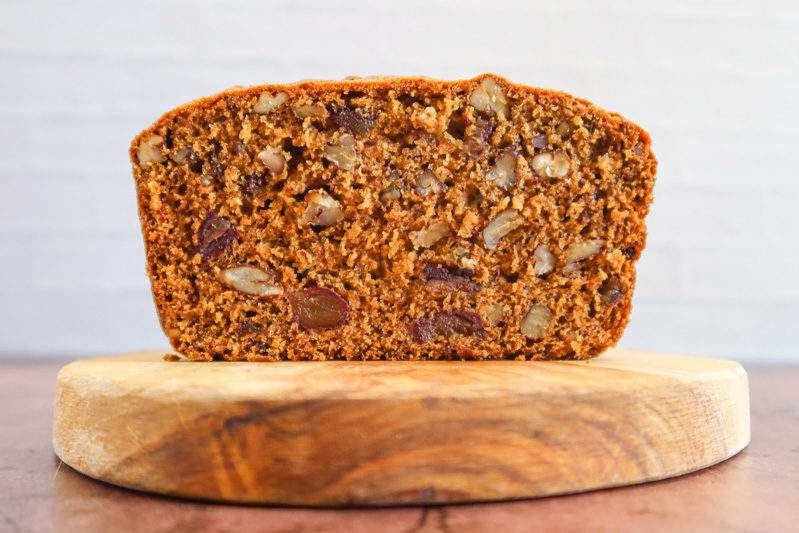 closeup of a sliced loaf of date nut bread