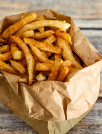 deep fried french fries in a paper bag