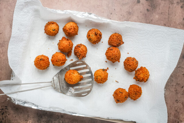 Fried hushpuppies on paper towels.