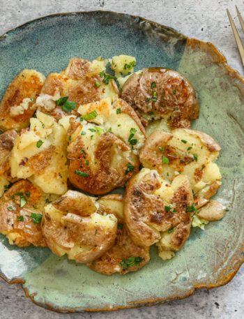 crispy fried smashed potatoes on a plate