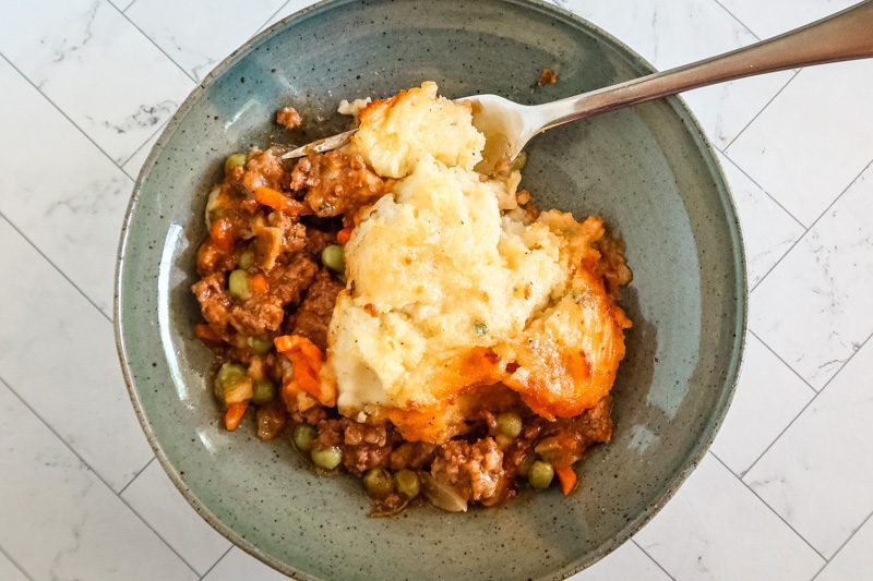 A serving of gluten free cottage pie in a bowl.
