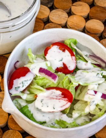 homemade buttermilk dressing drizzled on a tossed salad