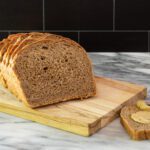 homemade pumpernickel bread on a cutting board
