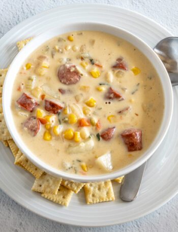 hot dog chowder in a bowl with mini saltine crackers on the side