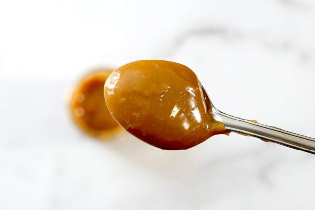 thick, rich dulce de leche on a spoon