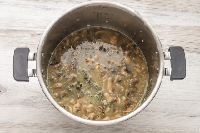 Instant Pot risotto prep: rice, wine, broth, and thyme are added to the Instant Pot.