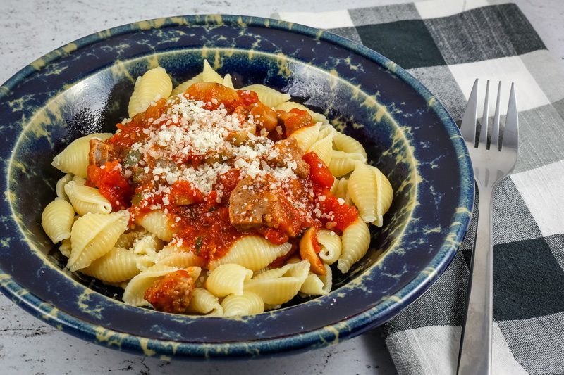 A closeup photo of Neapolitan pasta with Italian sausages and tomatoes.