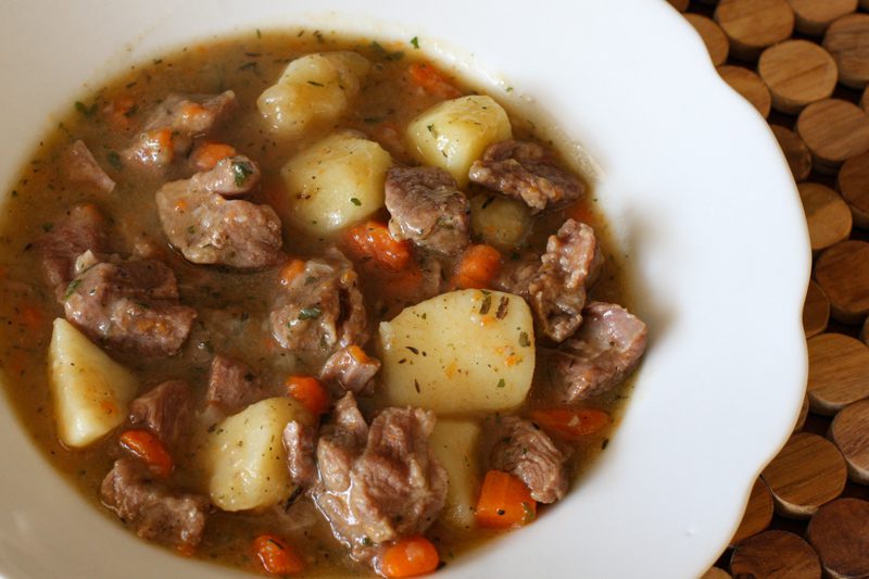 A bowl of old-fashioned beef stew with vegetables.