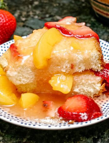 peaches and strawberry dessert sauce over angel food cake