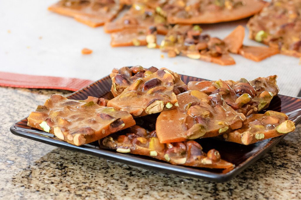 a serving plate with broken pistachio brittle candy