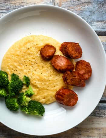 polenta with spicy andouille sausage on a plate