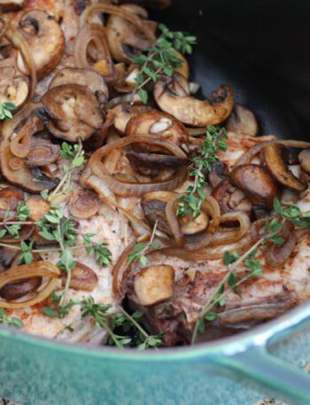 braised pork chops with mushrooms in a dutch oven