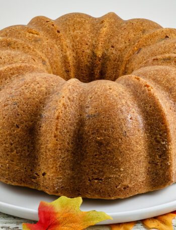 A brown sugar and pecan pound cake on a cake platter.