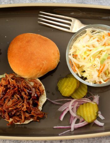 pulled pork sandwiches with coleslaw on the side
