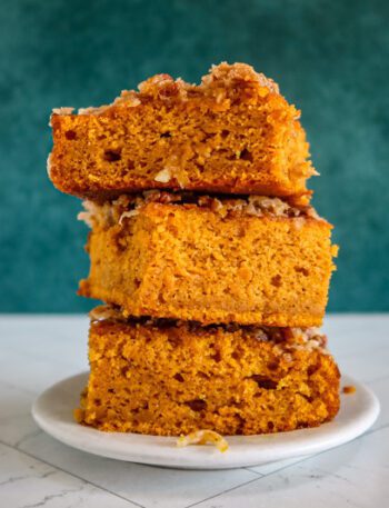 pumpkin cake with broiled coconut pecan topping, stacked on a plate