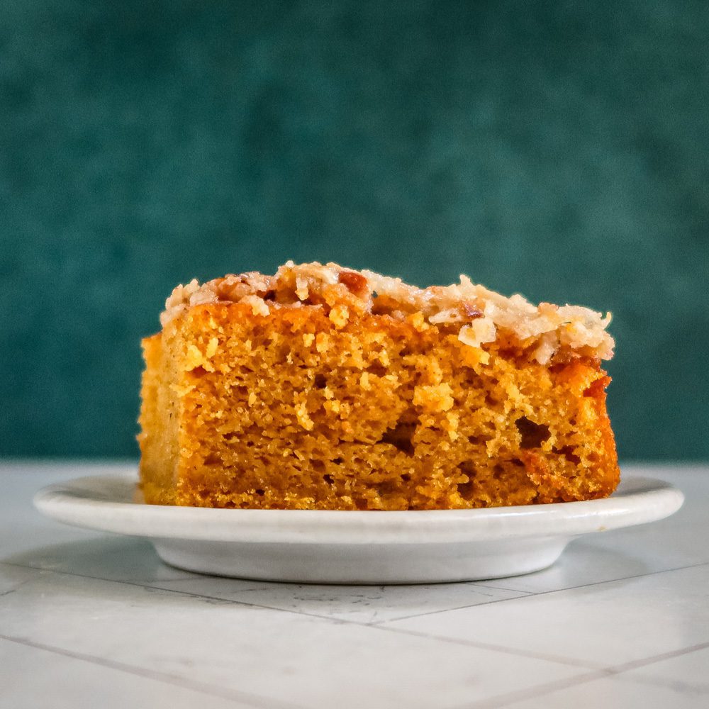 side view of the pumpkin cake with broiled coconut pecan topping