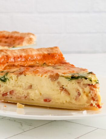 A slice of quiche lorraine on a plate