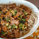 stir-fried beef and broccoli over noodles