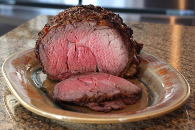 rib eye roast on a platter, sliced