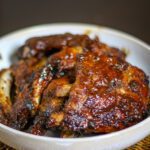 a serving bowl of slow cooker pork spareribs with maple barbecue sauce