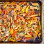 fajitas in the sheet pan, chicken, peppers, and onions